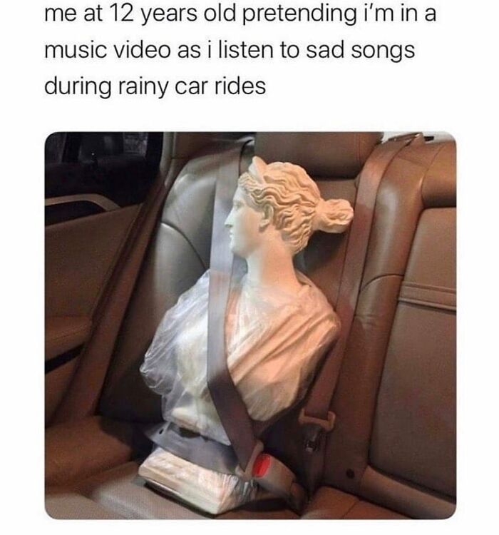 Parenting meme showing statue buckled in car seat pretending to be in music video