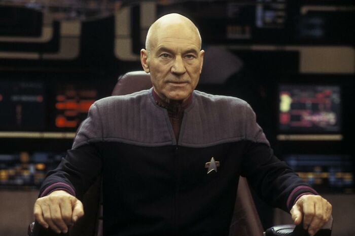 Star Trek Captain Picard wearing uniform on bridge set