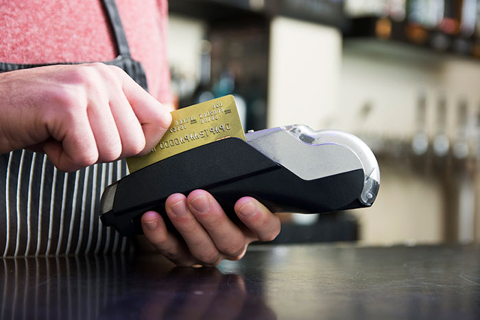 A person using a credit card machine, symbolizing how Walmart shoppers can pay for their purchases. A person using a credit card machine, symbolizing how Walmart shoppers can pay for their purchases.