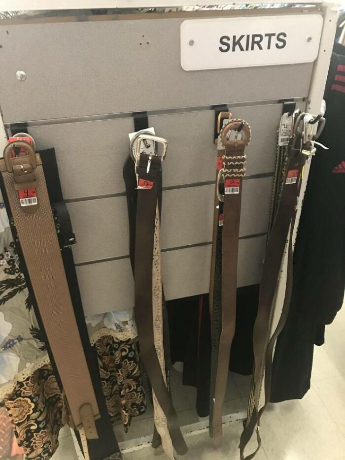 A retail rack clearly labeled SKIRTS but displaying only belts, a humorous common sense fail.