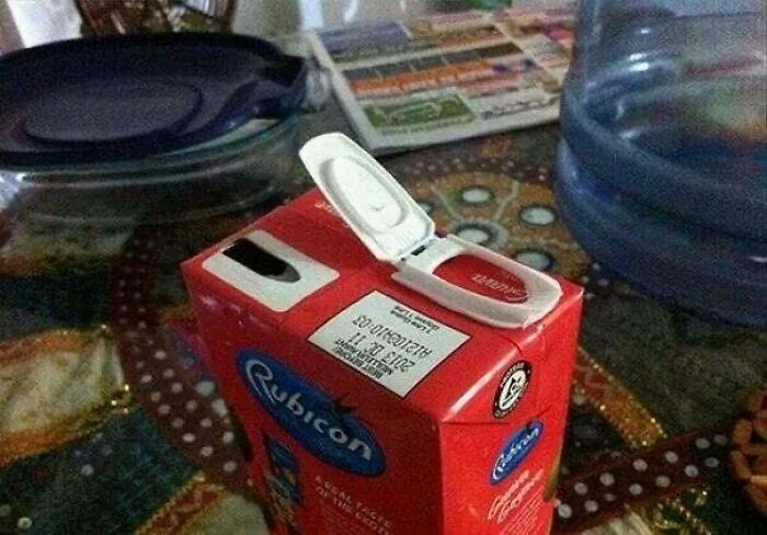 A juice carton with an upside-down opening, showcasing a You Had One Job fail.