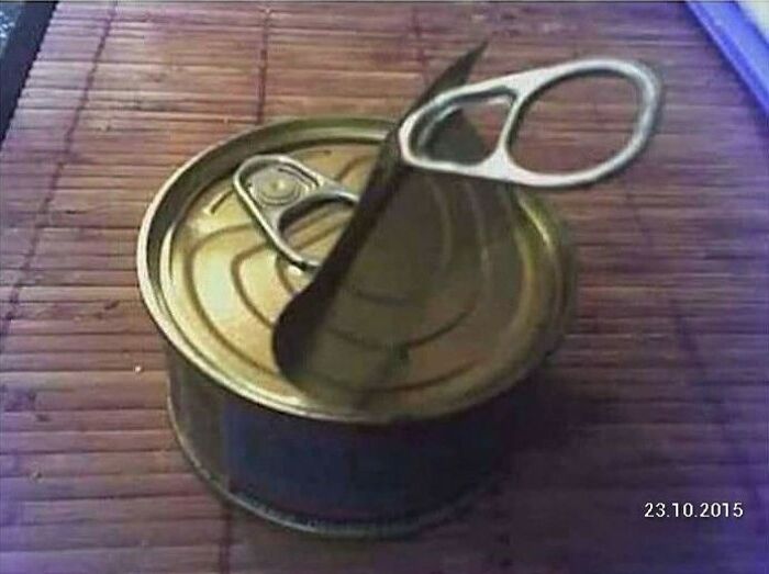 A tin can with two pull tabs, one broken and one intact, showing a You Had One Job fail with common sense.
