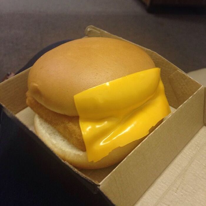 A burger with cheese placed incorrectly, a ridiculous You Had One Job fail due to common sense not being common.