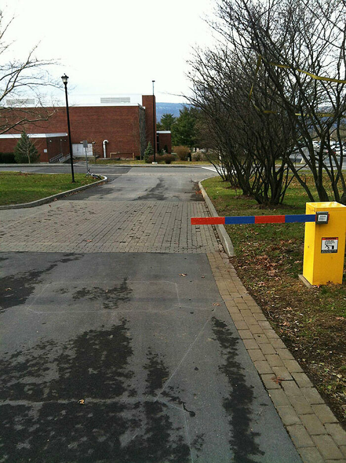 A parking barrier blocking a path next to the road, demonstrating a “You Had One Job” fail.