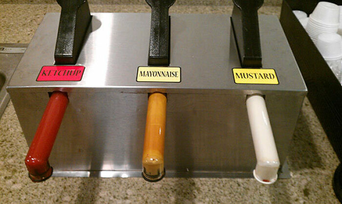 A condiment dispenser fail where the labels for ketchup, mayonnaise, and mustard are mismatched with the actual condiments, a funny common sense fail.