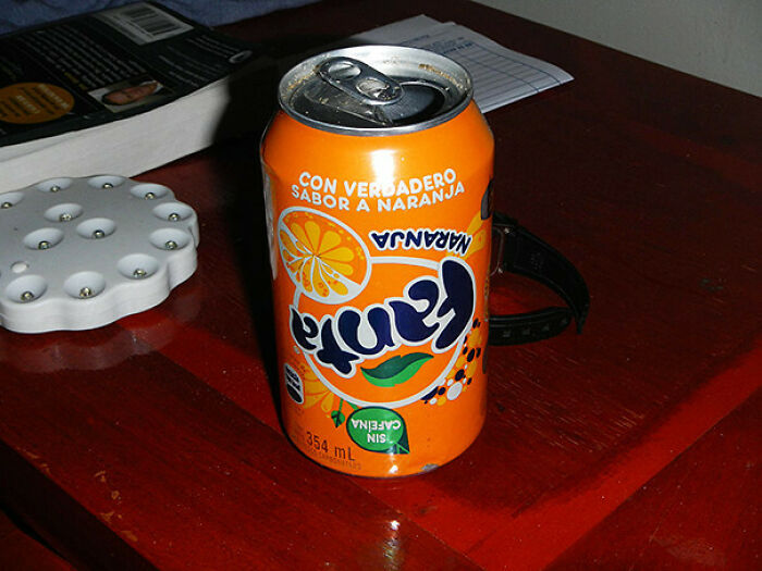 A can of Fanta orange soda on a table, illustrating a You Had One Job fail.