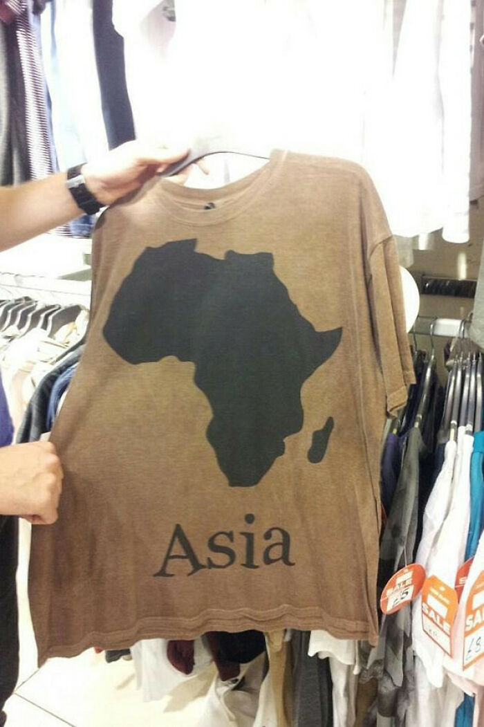 A brown t-shirt with a map of Africa and the word 'Asia' printed below it, a 'You Had One Job' fail.