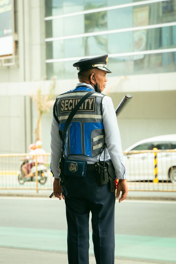 A security guard on duty, looking serious as people realize it was not a joke.