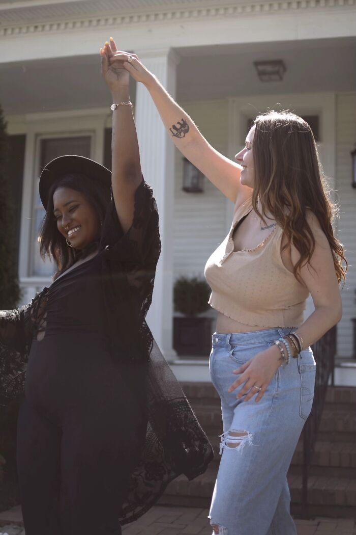 Two strangers dancing happily outdoors, illustrating the wholesome photo trend.