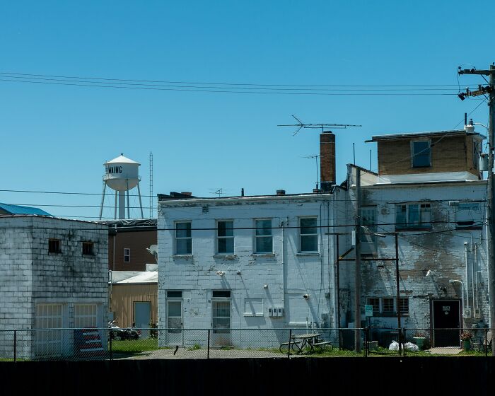 Old building with water tower in small town reflecting reconnection regrets