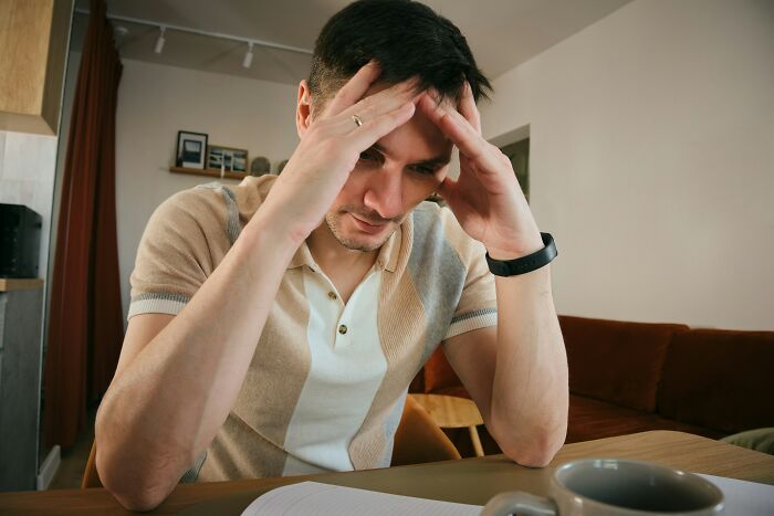 Stressed man contemplating reconnection with old friends and regret