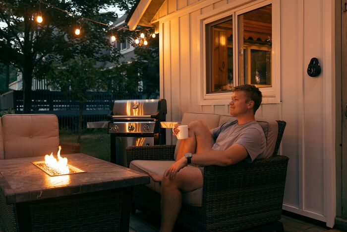 Man relaxing outdoors reflecting on regrets after reconnecting with old friends