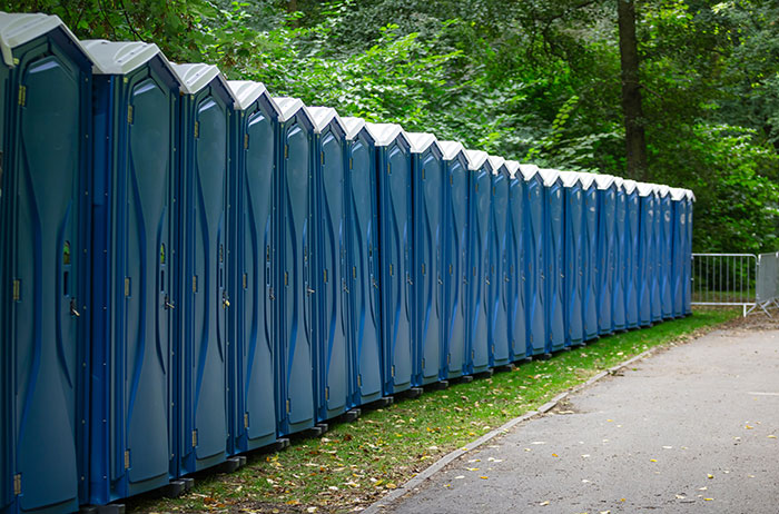 Row of blue portable toilets representing odd sanitation jobs