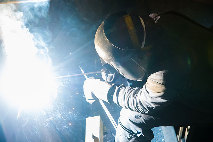 Person welding with safety helmet showing strange job work