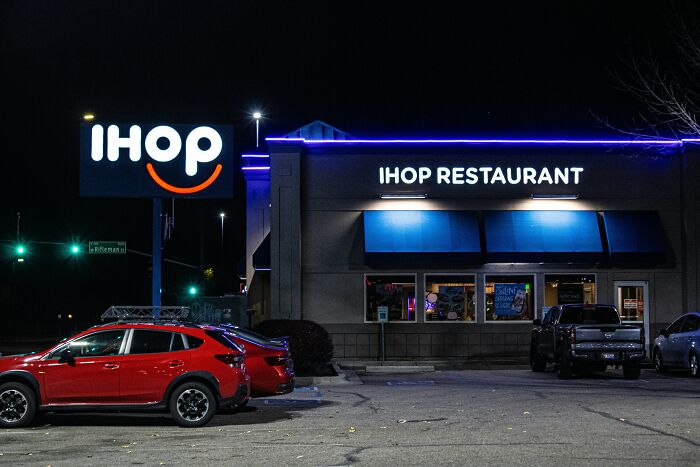 An IHOP restaurant at night, highlighting things to experience while visiting the US.