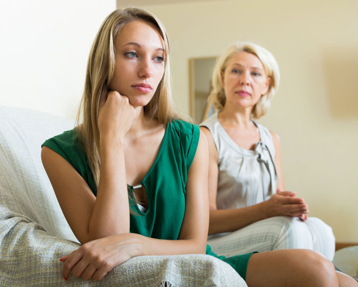 Tense moment between woman and her mother-in-law showing strained relationship Tense moment between woman and her mother-in-law showing strained relationship