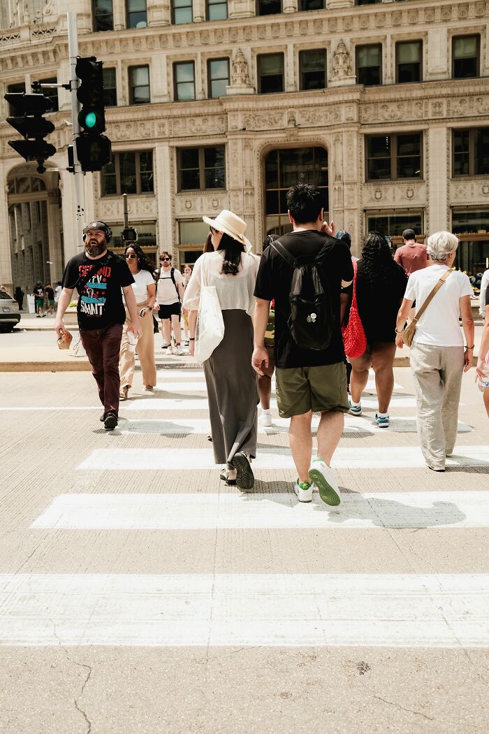 Pedestrians crossing a city street, unaware of the wild coincidences that might happen.