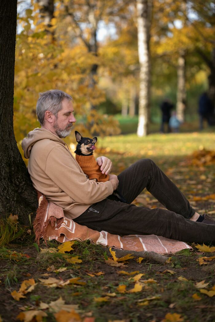 Man sitting alone with dog in park symbolizing moments men realized life would never be the same