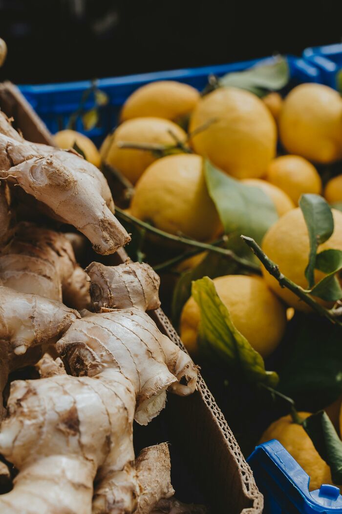 Fresh ginger roots and yellow lemons in market display food facts