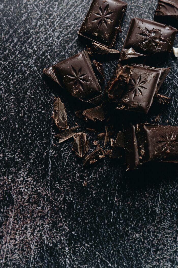 Chunks of dark chocolate pieces on black textured surface food facts