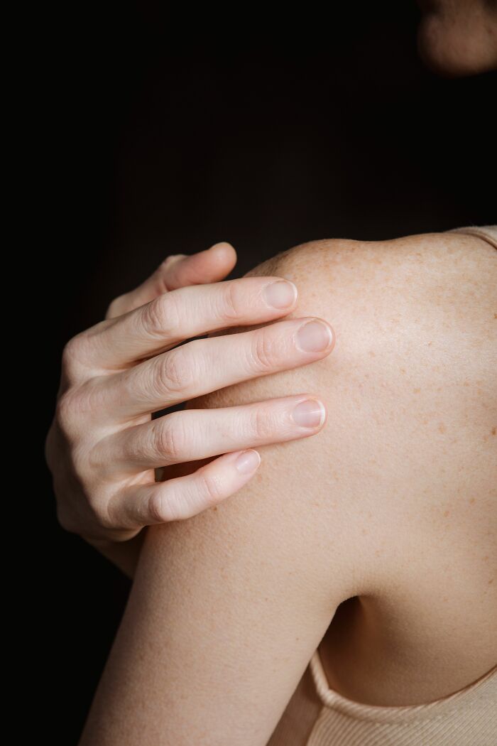 A close-up of a person's shoulder and hand. Delving into NSFW facts about human bodies.