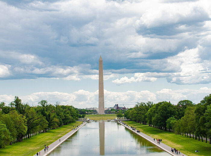 The Reflecting Pool and Washington Monument under a cloudy sky.