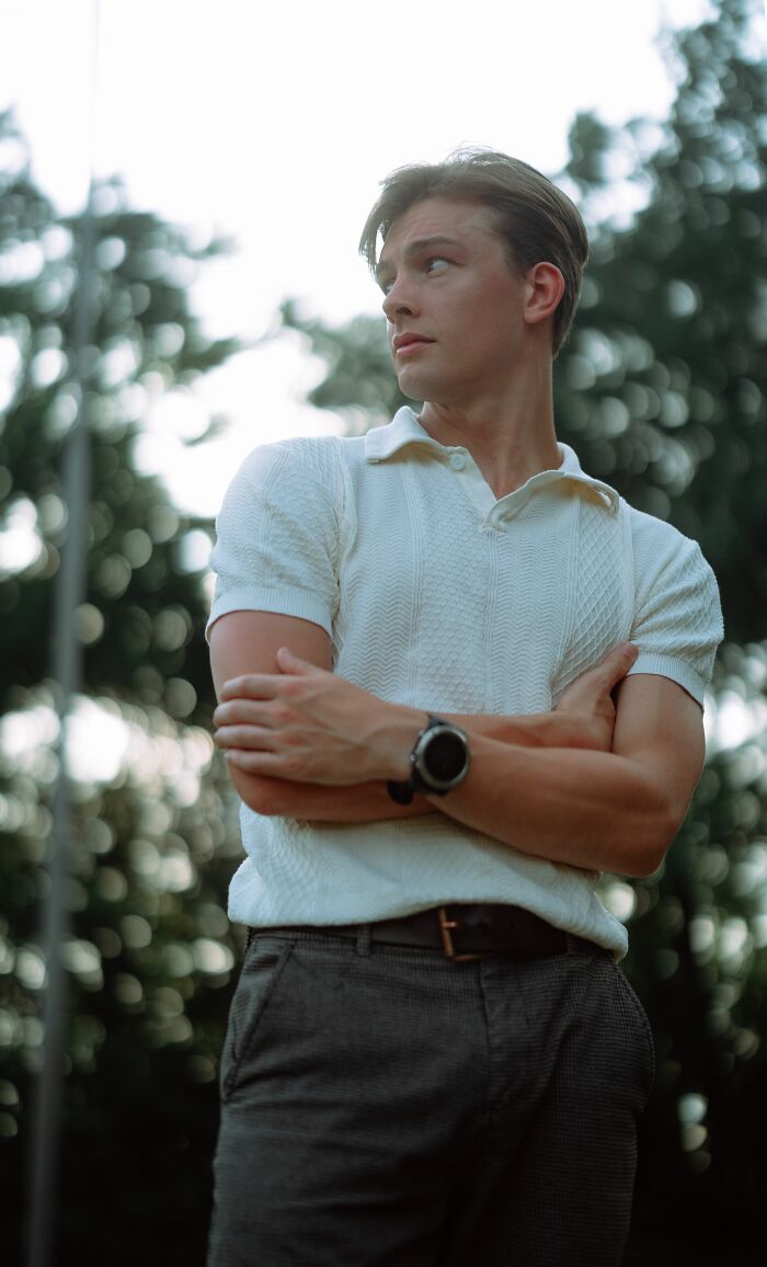 A young man with his arms crossed, showing a confident pose of human bodies.