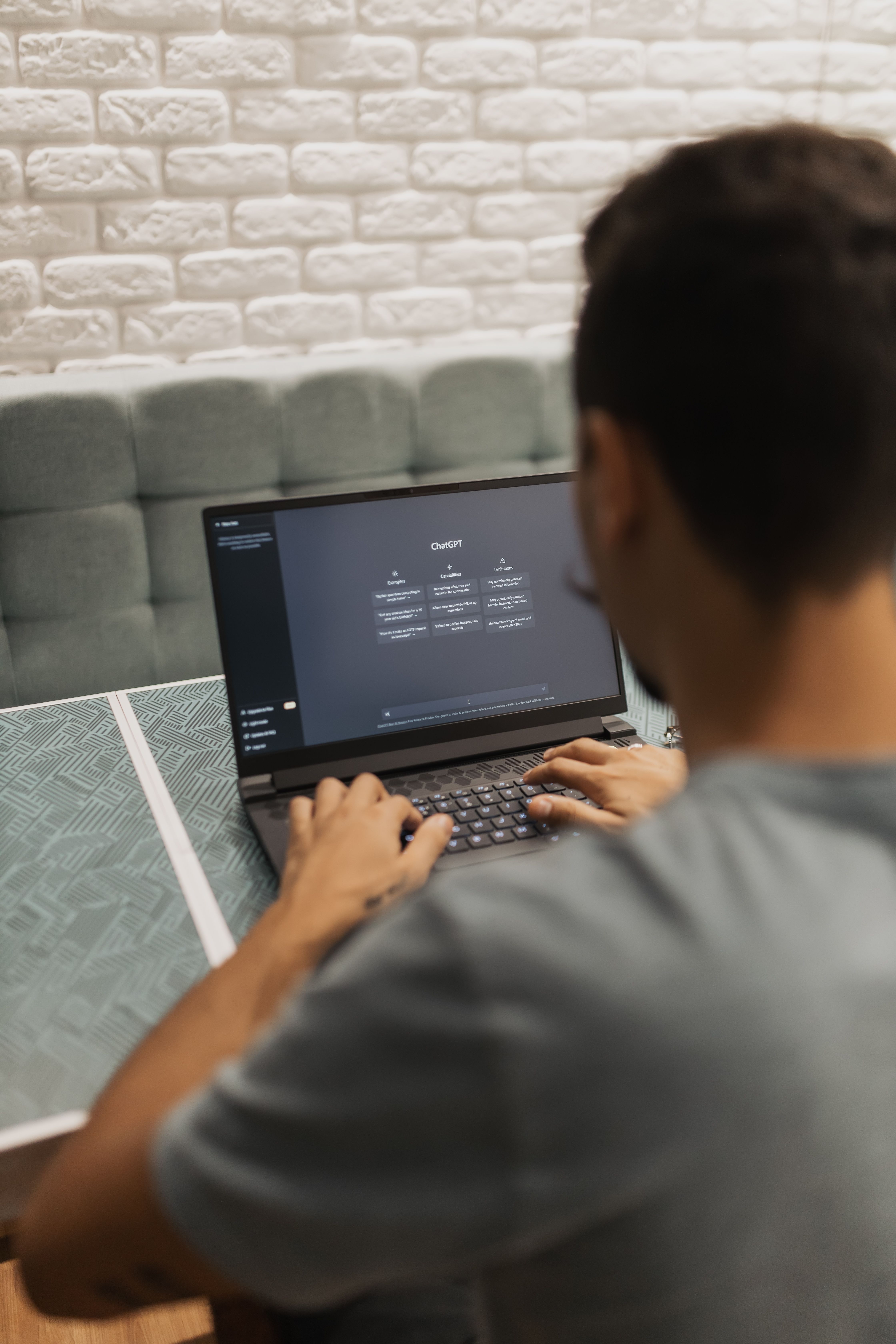 Man using ChatGPT on laptop immersed in AI interaction at home Man using ChatGPT on laptop immersed in AI interaction at home