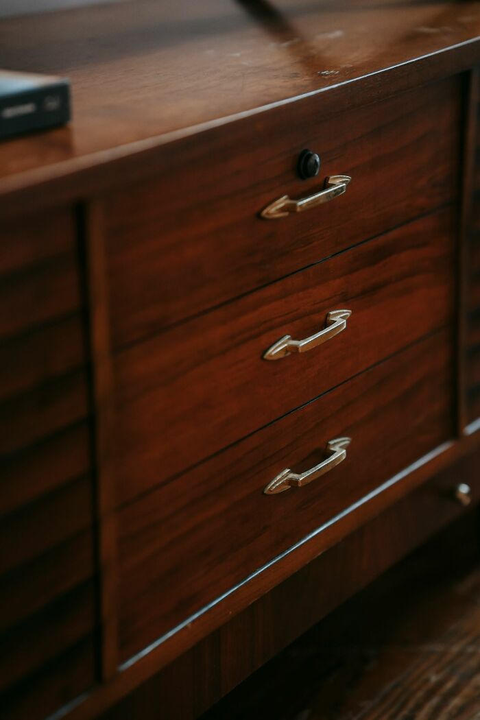 Close-up of a wooden dresser with three drawers. Perhaps this is where they hide their partners phone.