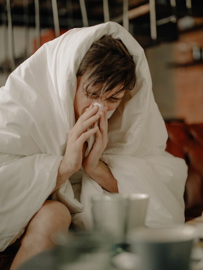 A man wrapped in a blanket, blowing his nose. Learn about NSFW facts about human bodies and health.