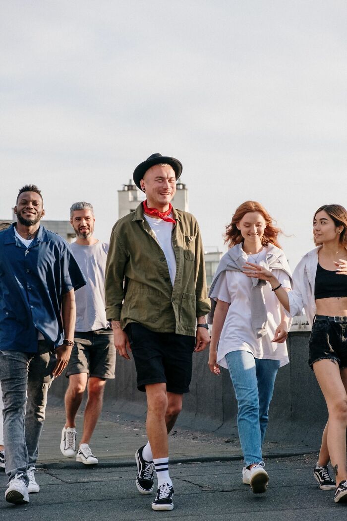 A diverse group of friends walking together on a rooftop, representing crazy but true facts.