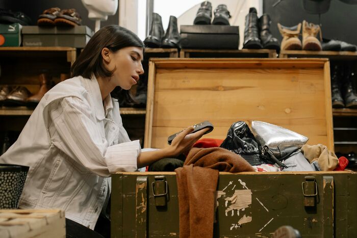 Woman searching through storage chest uncovering family secrets