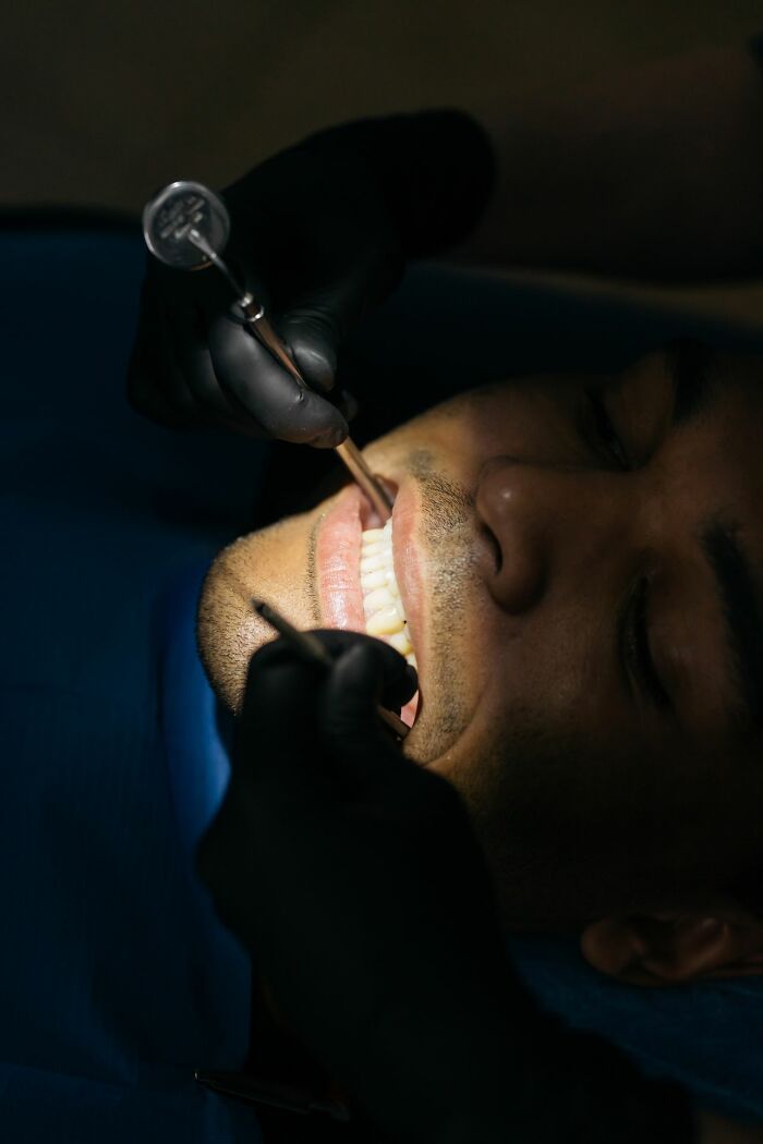 A person undergoing a dental procedure, illustrating a type of physical pain.