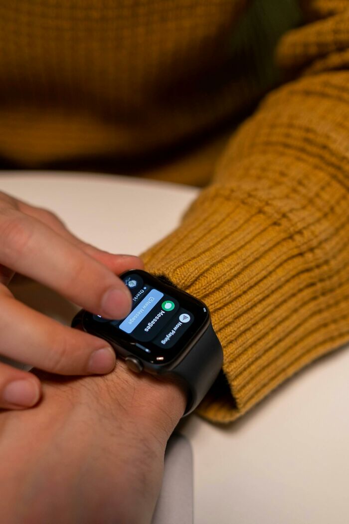 Person checking messages on smartwatch hinting at infidelity