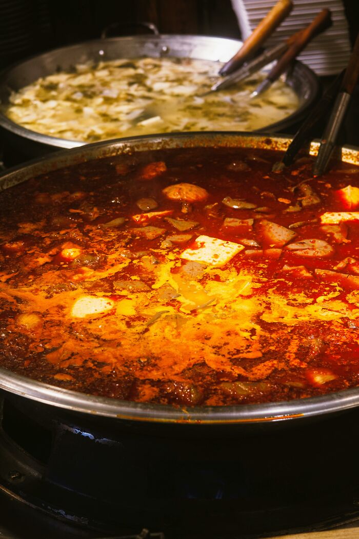 Two large pans of soup with ladles food facts