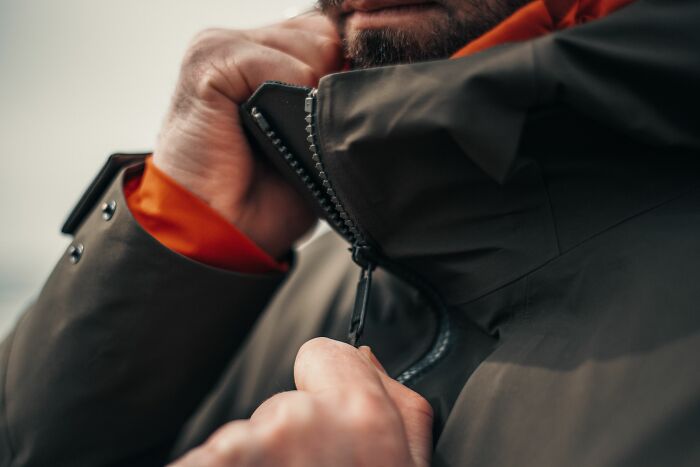 A man in a jacket in full rage mode, zipping up his coat, unable to take it anymore and snapping.