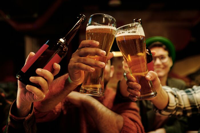 People clinking beer glasses, celebrating, contrasting with feeling full rage mode and snapping.