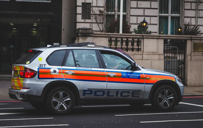 Metropolitan police car parked on street in London city scene