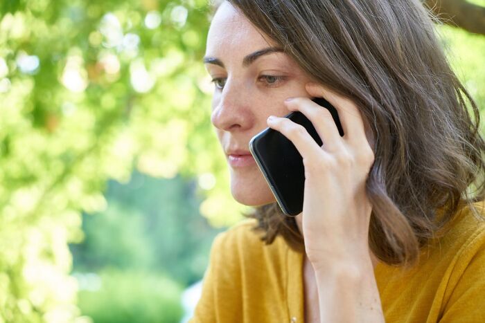 Concerned woman on phone about infidelity revelations