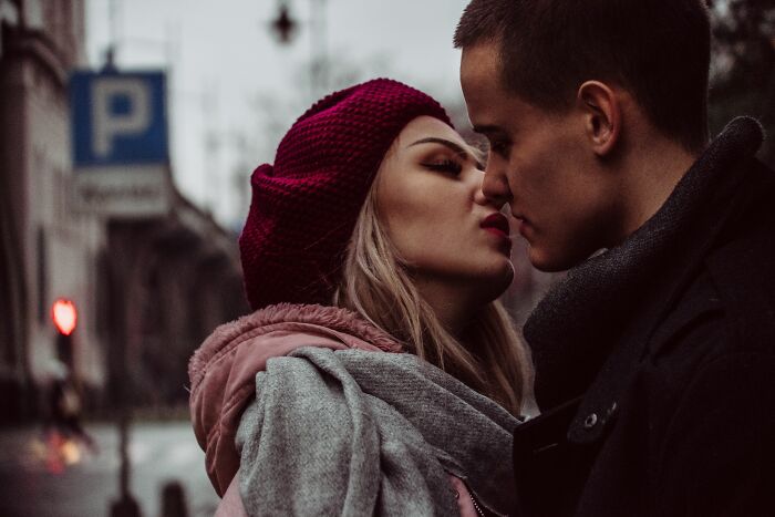 A couple nearly kissing on a street; perhaps a moment before full rage mode or couldn't take it anymore.