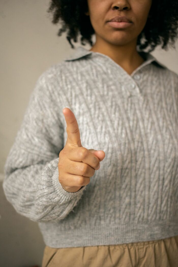 Entitled parent pointing finger in a warning gesture indoors