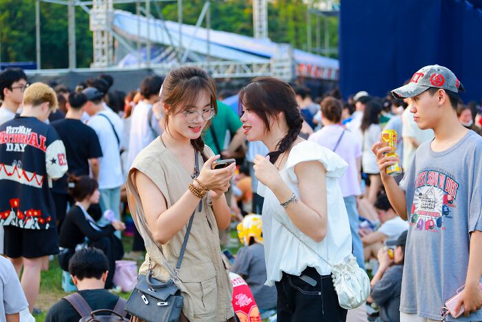 Young people socializing at an outdoor crowd event modern world audacity