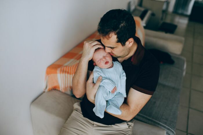 A man holding a baby, depicting one of the worst things people found on partners phone.