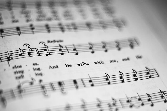 Close-up of sheet music focusing on song lyrics and musical notes for brain twisting songs