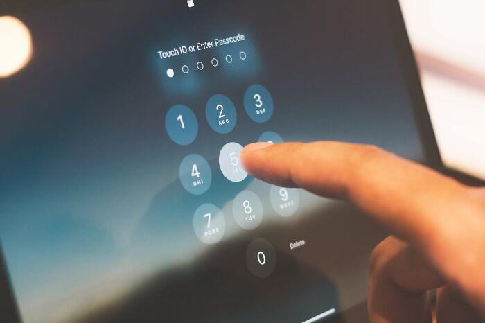 Finger entering passcode on phone in infidelity story context