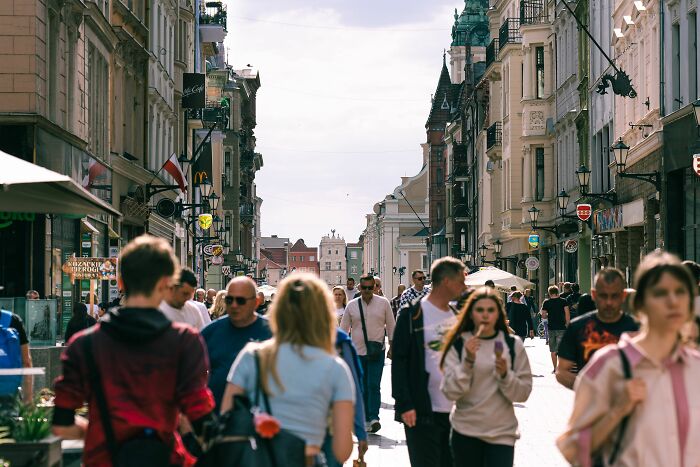 A bustling city street filled with pedestrians and historic buildings, illustrating cool, interesting, and surprising facts about urban life.