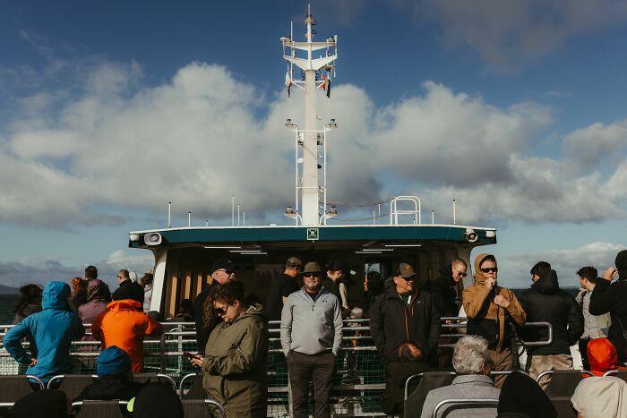 People on the deck of a boat, against a cloudy sky, hinting at a wild coincidence at sea.