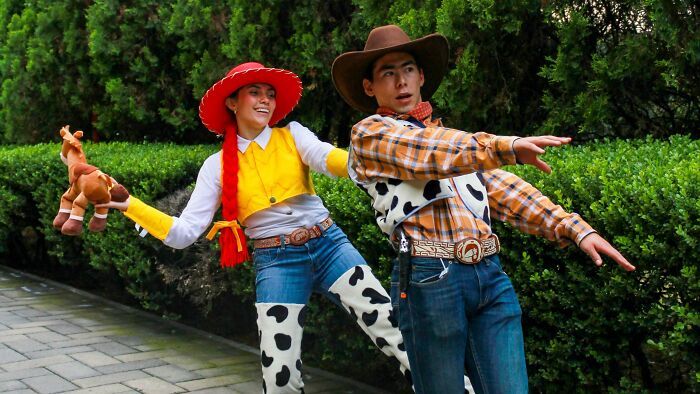 People dressed as Woody and Jessie from Toy Story, showcasing iconic outfits from movies. People dressed as Woody and Jessie from Toy Story, showcasing iconic outfits from movies.