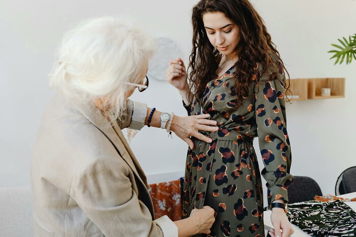 Woman fitting a dress with tailor before wedding