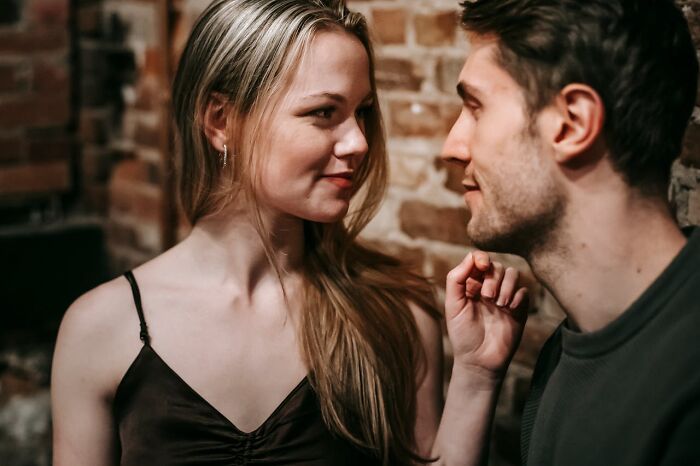 Couple flirting intimately suggesting infidelity stories